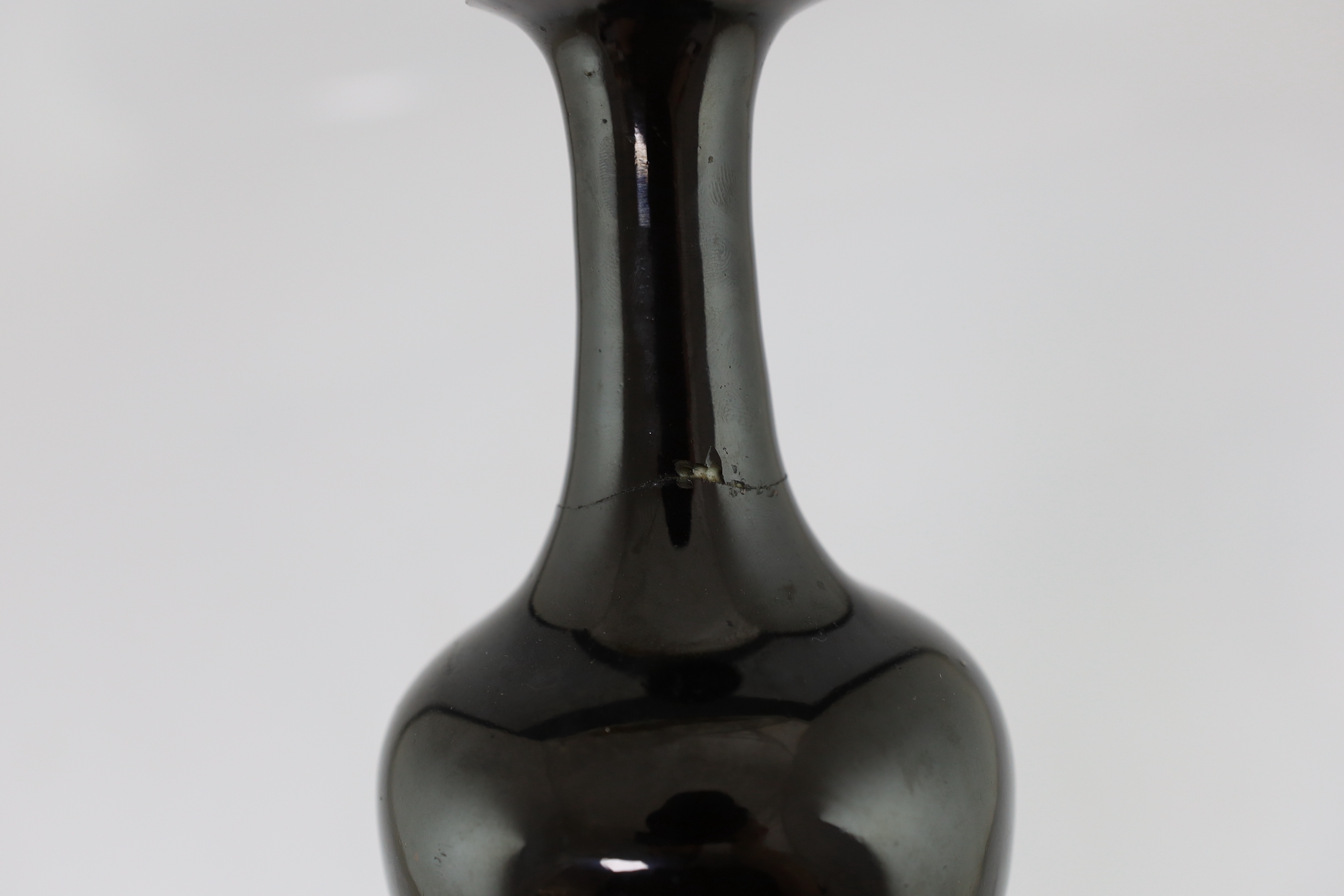 A near pair of Chinese mirror-black glazed vases, Kangxi period, both broken and glued